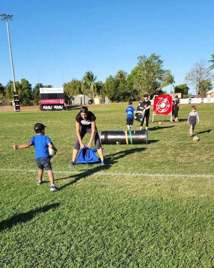 Kids playing Sense Rugby on a field
